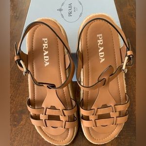 Prada tan leather gladiator sandal with espadrille trim on platform wedge.